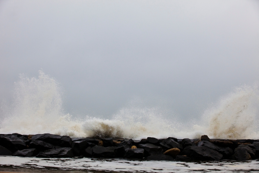 jetty, big waves. water. wave spray.